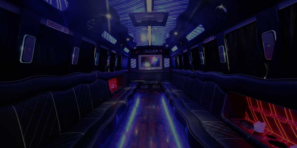 Party bus interior with LED ceiling lights and wraparound seating