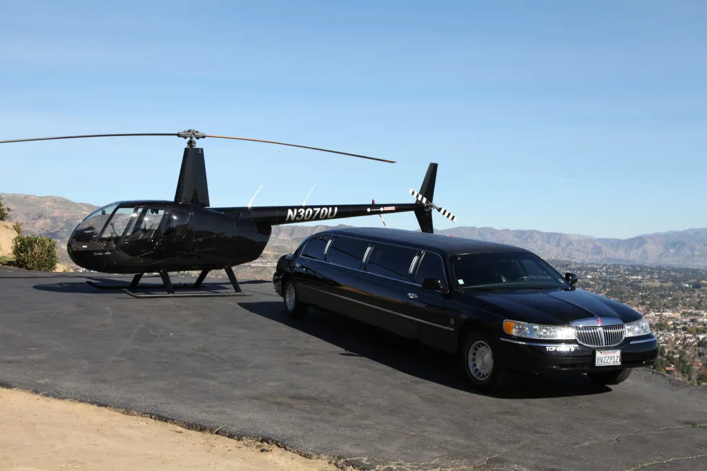 Black stretch limousine parked on a hilltop above the city