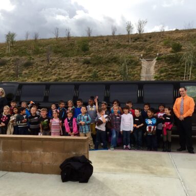SUV limousine with children and two limo drivers.
